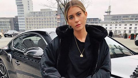 Mrs Bella post vor ihrem Auto